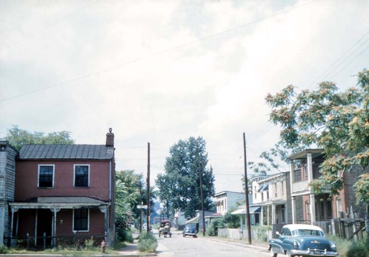 Carrington Street in 1980: frame houses, utility poles and parked cars along a narrow road